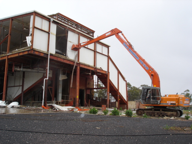 long reach excavator demoliting abbatoirs